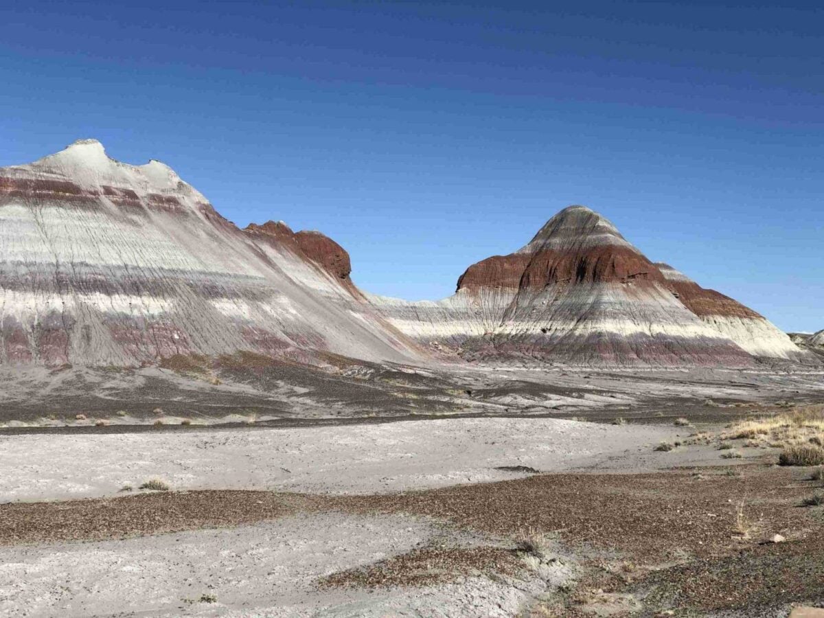 Giant striped mounds stand next to a road.