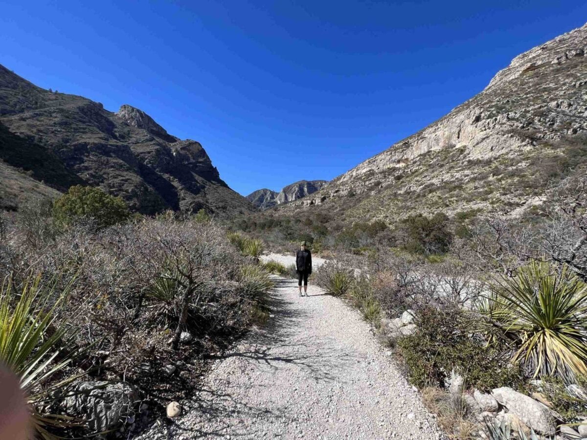 A woman hikes a trail in the Guadalupe Mountains