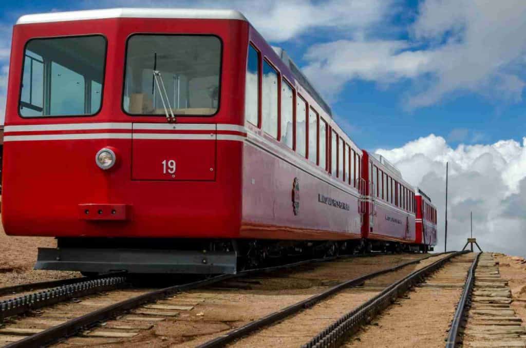 red train on tracks - cog railway