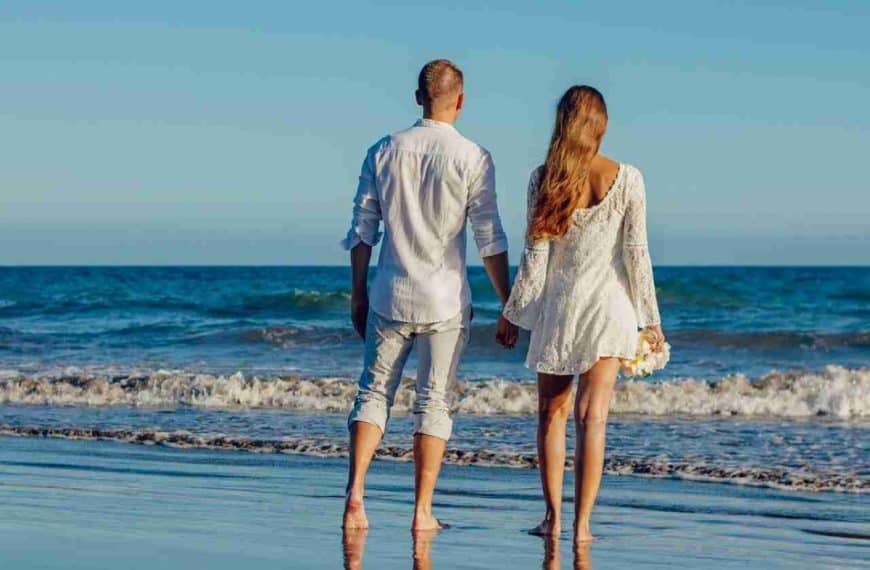 couple holding hands on the beach