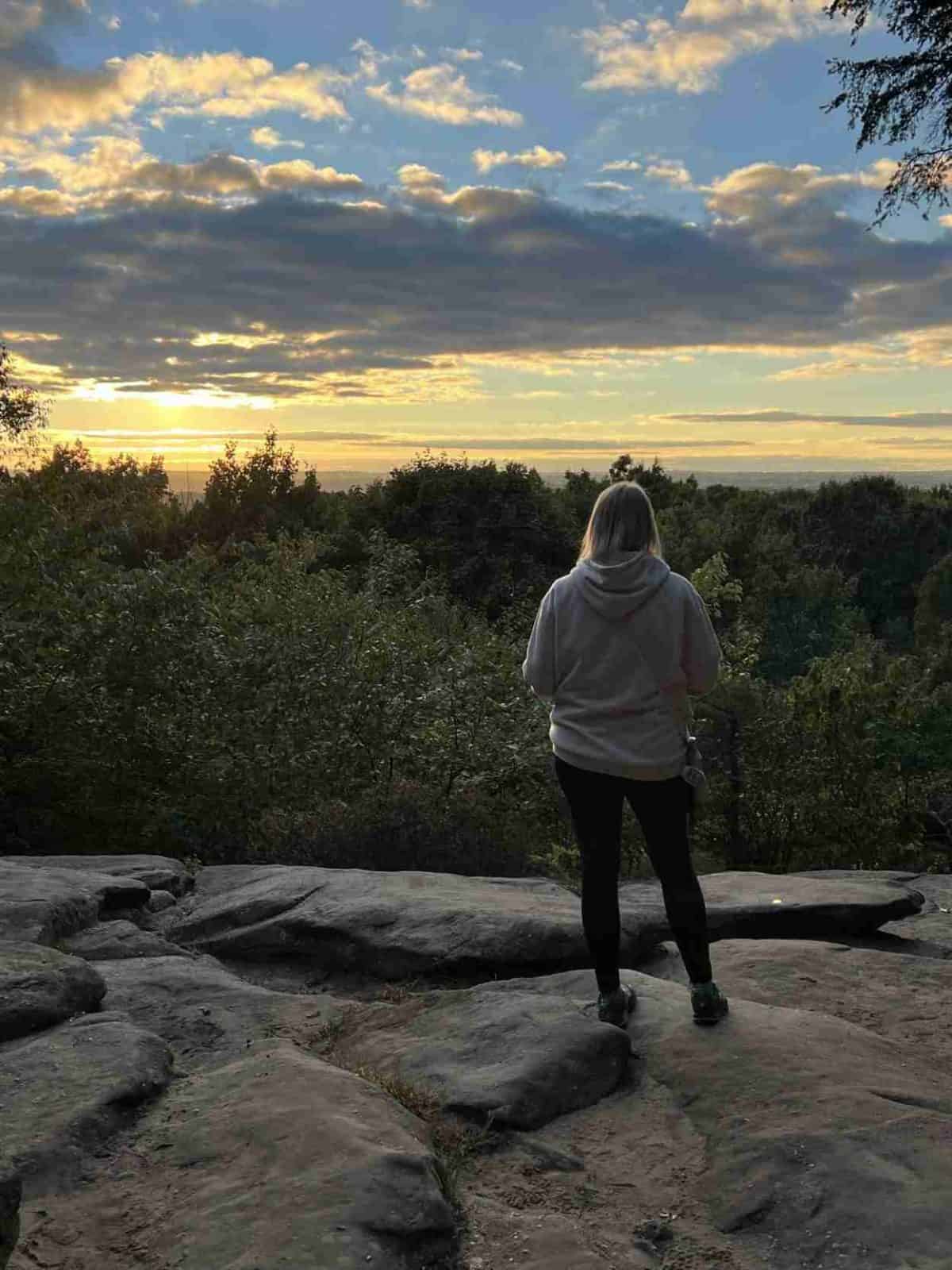 A woman enjoys a view of sunset from Ledges Overlook, Cuyahoga Valley National Park