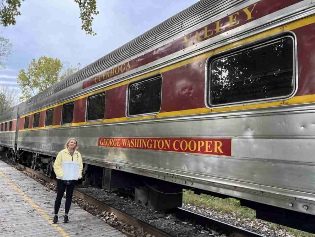 A woman stands beside a train - Cuyahoga Valley Scenic Railroad, Cuyahoga Valley National Park, OH