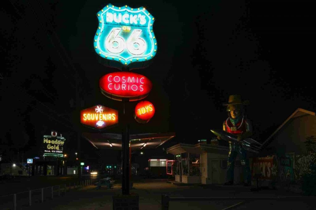 Route 66 sign lit up at night