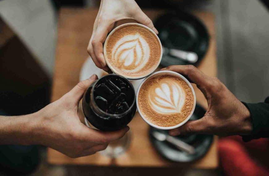 three person holding cups of coffee