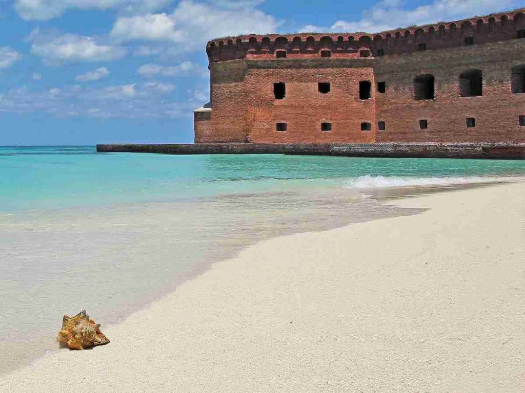 brown concrete building on beach during daytime