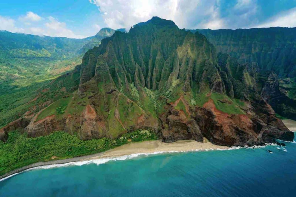 aerial photography of mountain range along coast of Kauai