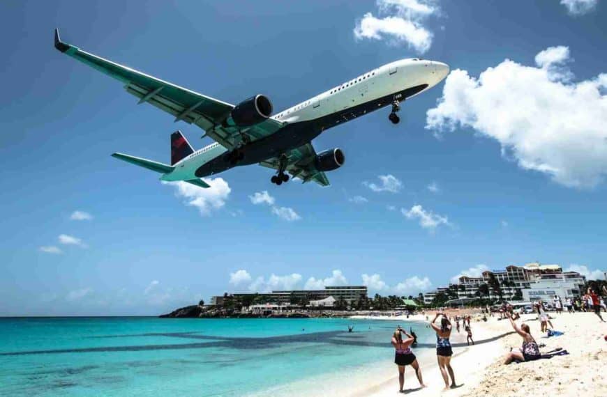 plane landing near seashore during daytime