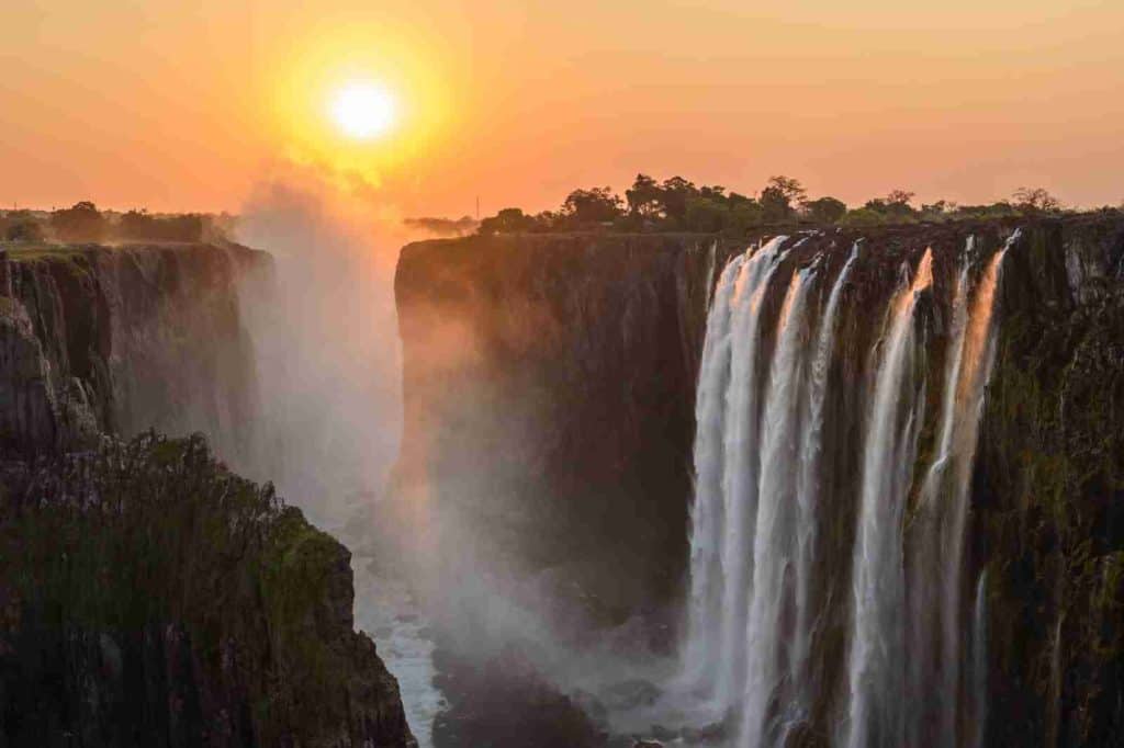 waterfalls on brown rocky mountain during sunset - African Safari