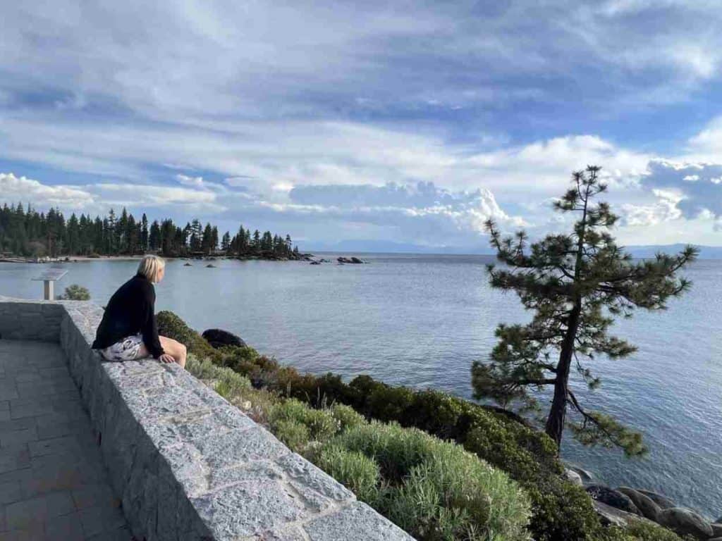 Sitting on a wall to enjoy a view of Lake Tahoe
