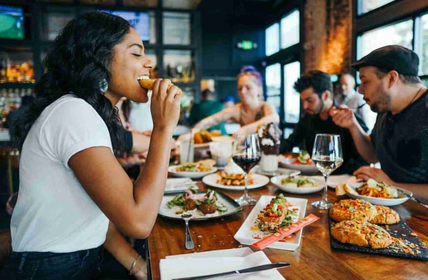 culinary tourism - woman in white shirt eating