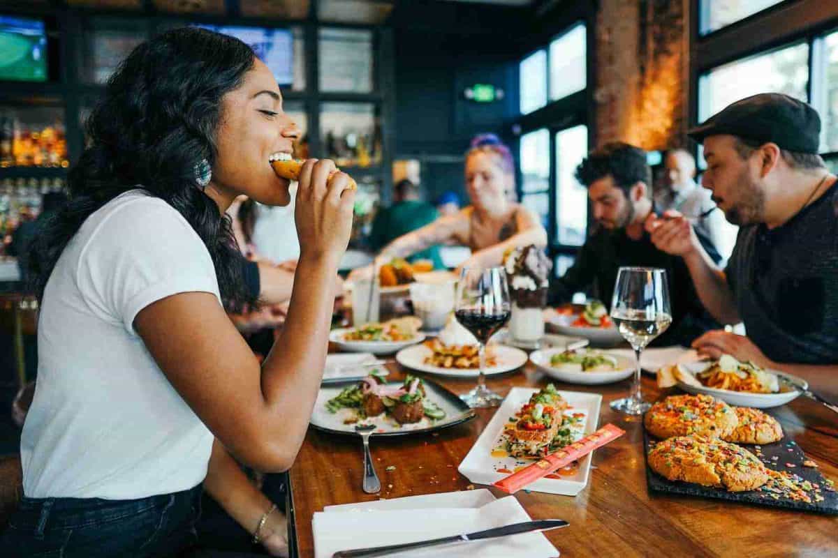 culinary tourism - woman in white shirt eating