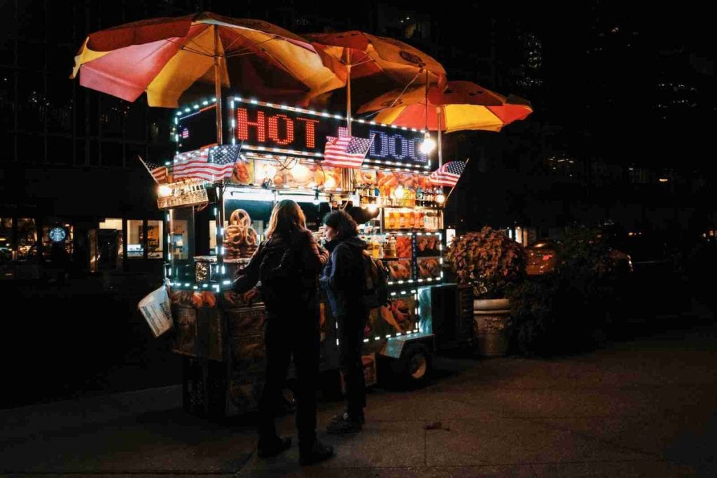 hot dog vendor cart at night in NYC