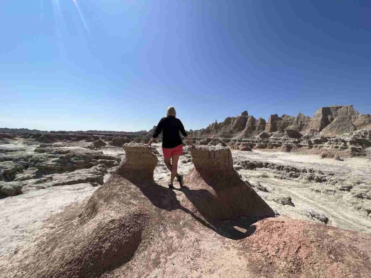 view on Door Trail A woman pauses during a hike on the Door Trail in the Badlands