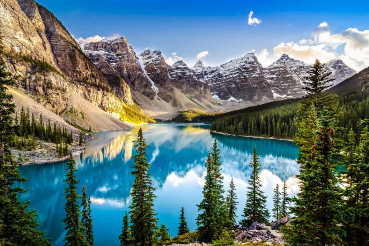 view of mountains, trees, and a blue lake in Banff