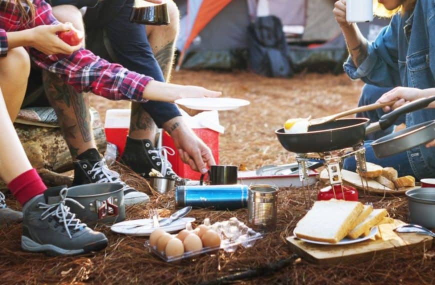 camping meals - friends preparing breakfast at a campsite