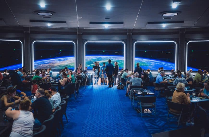 a group of people standing in front of a large screens at Space 220