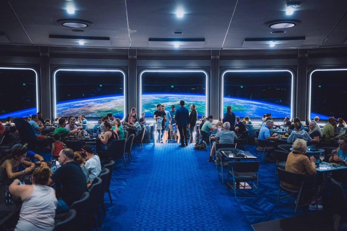 a group of people standing in front of a large screens at Space 220
