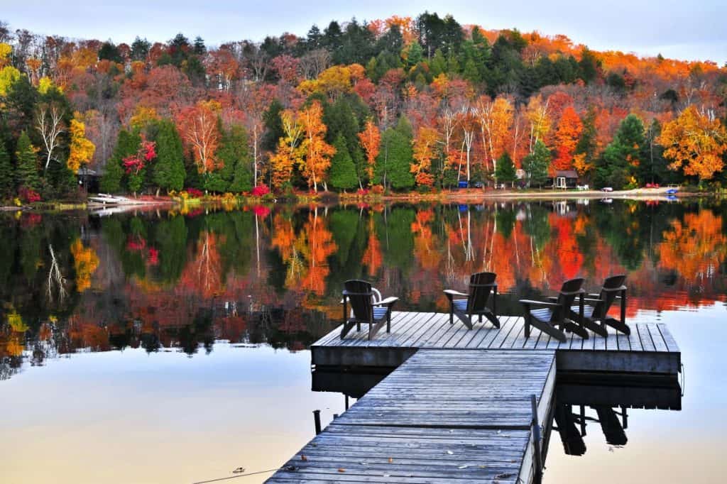 Chairs on a lake dock in autumn