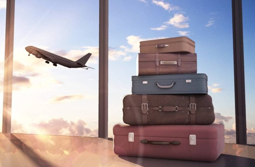Package luggage sits next to a window with a plane flying in the background