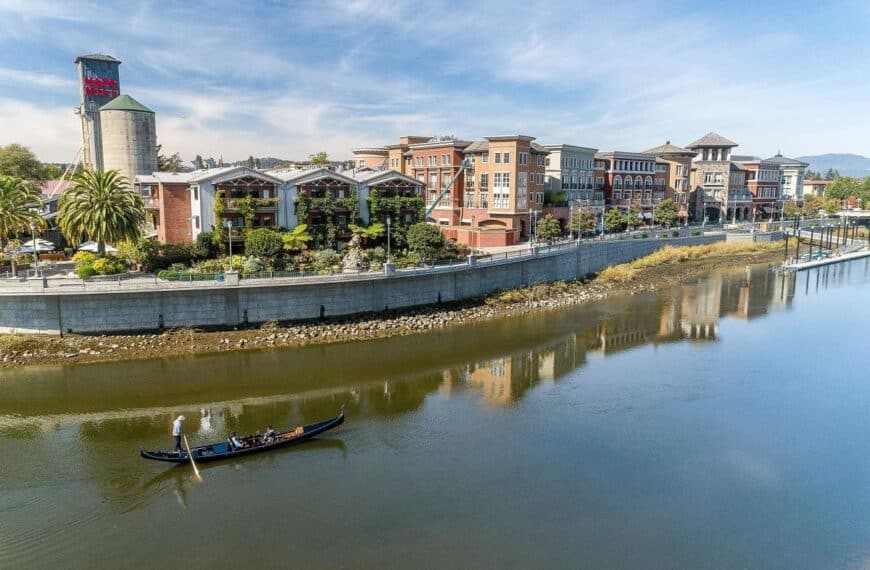 A gondolier guides a gondola along Downtown Napa on the Napa River