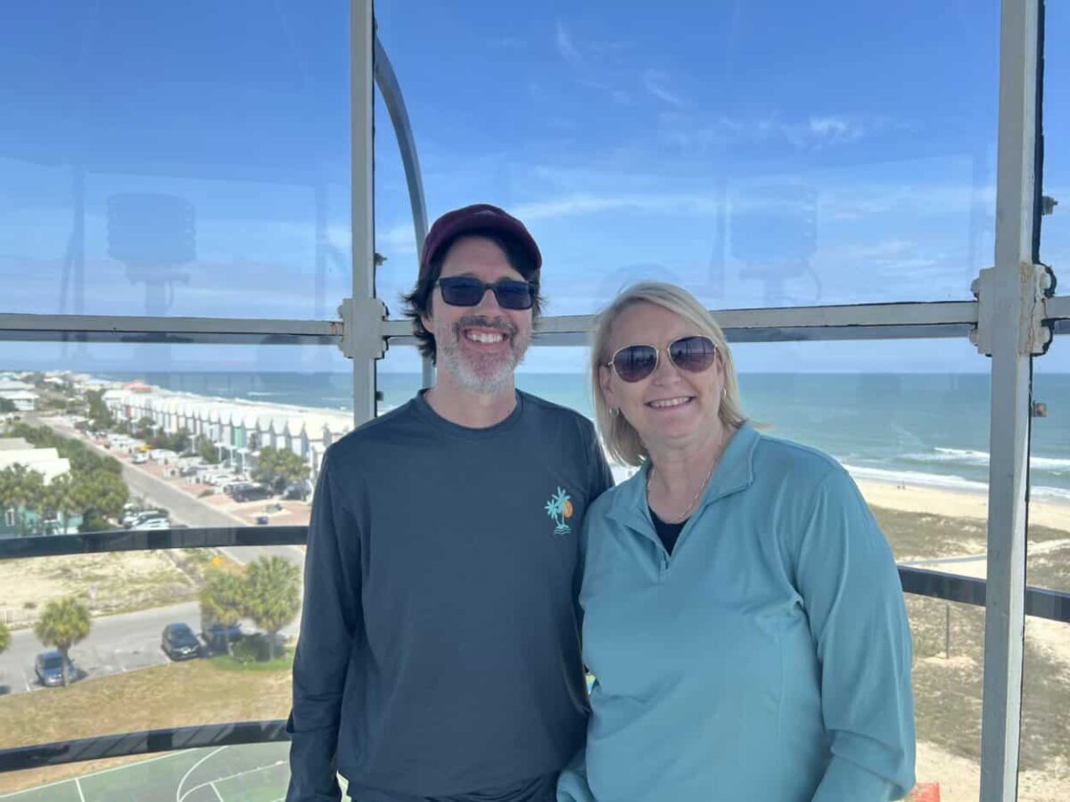 Scott McConkey and Julie McConkey of the Miles with McConkey Travel Blog pose for a picture inside the St. George Island Lighthouse lantern room.