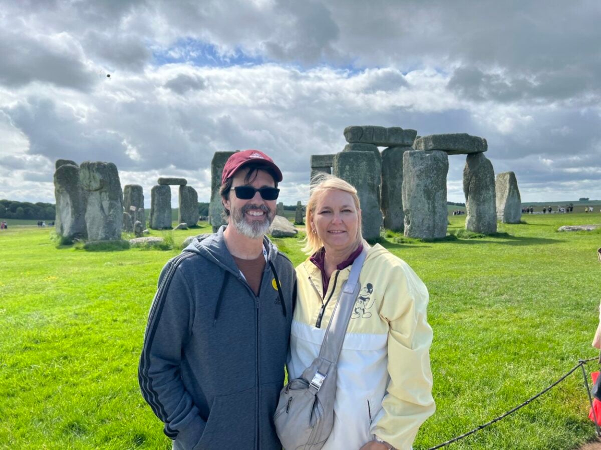 Scott and Julie McConkey of the Miles with McConkey Travel Blog pose for a picture at Stonehenge, England.