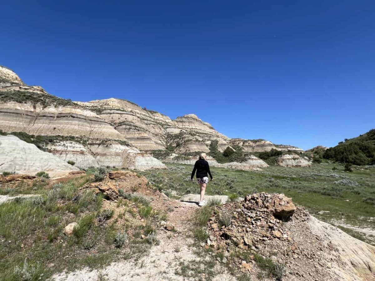 A woman walks near the badlands in Theodore Roosevelt National Park, ND