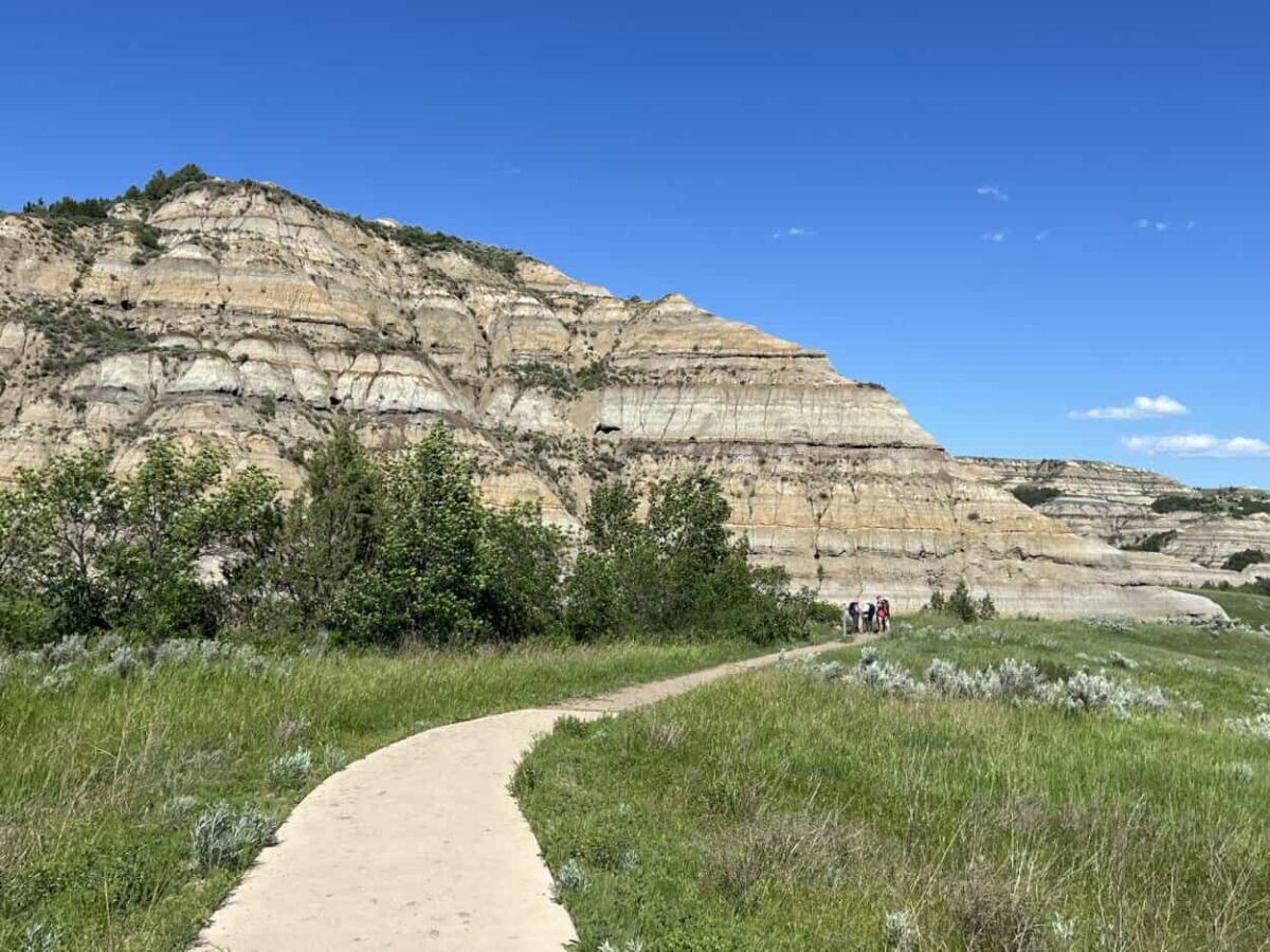 Hikers prepare to go on the trail near badlands