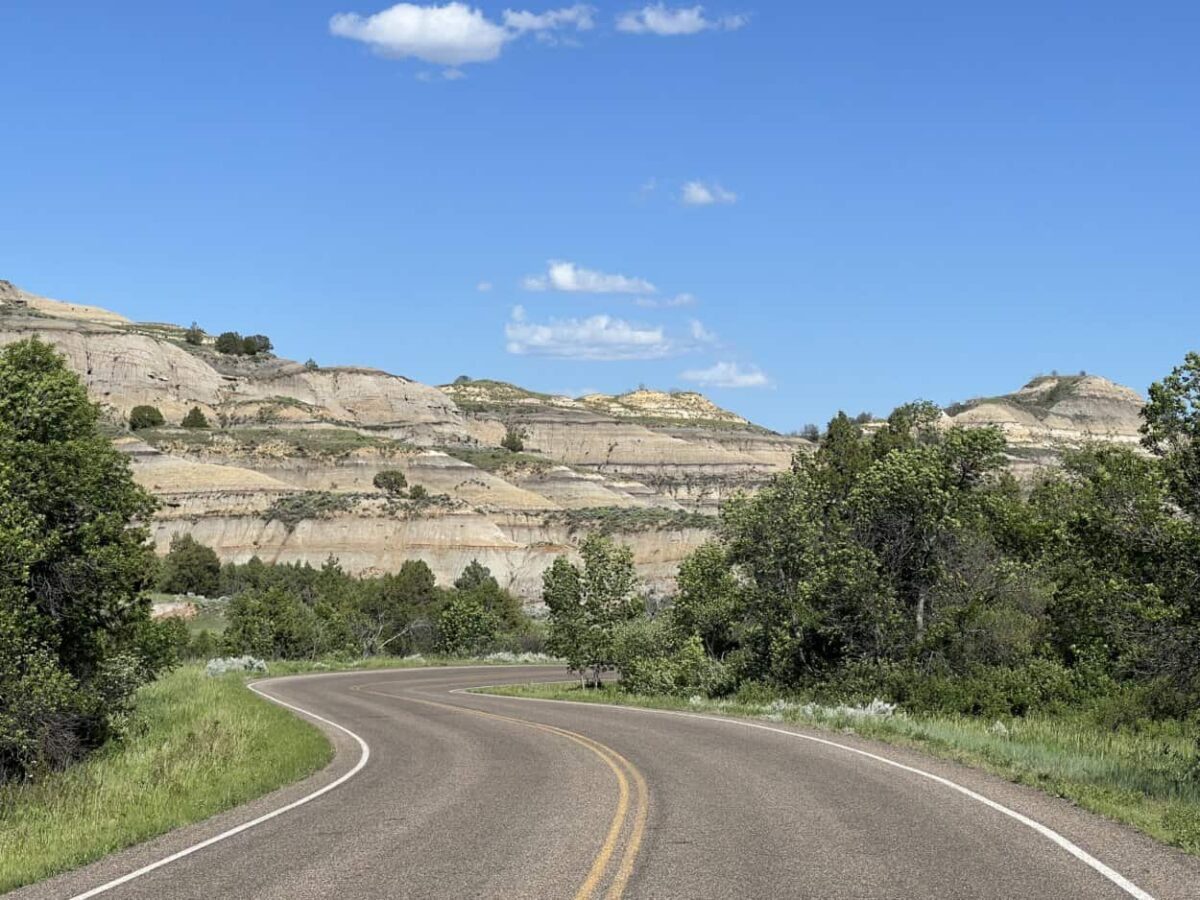 A road winds through badlands.