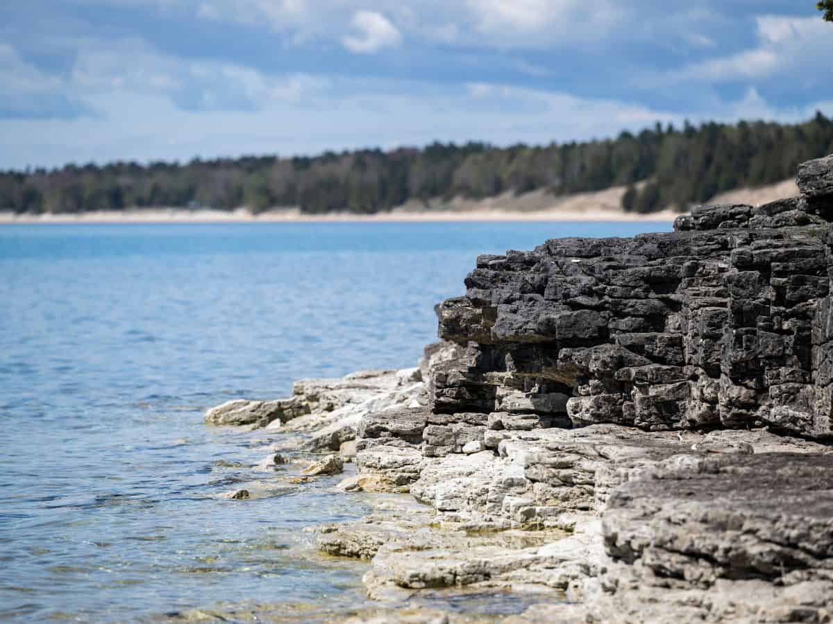 Lake waters lap at the Whitefish Dunes State Park shore