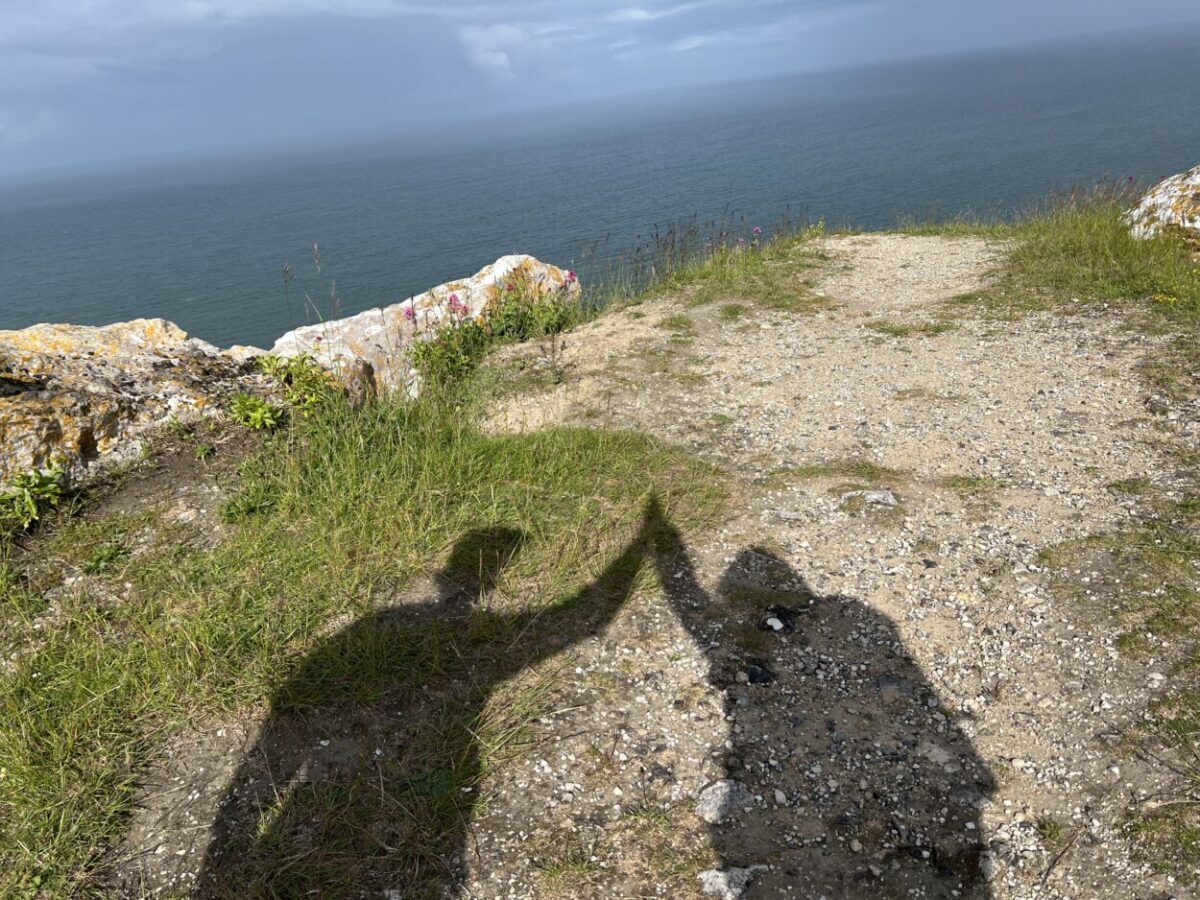 Scott McConkey and Julie McConkey of the Miles with McConkey Travel Blog perform their signature shadow high five in Portland, England