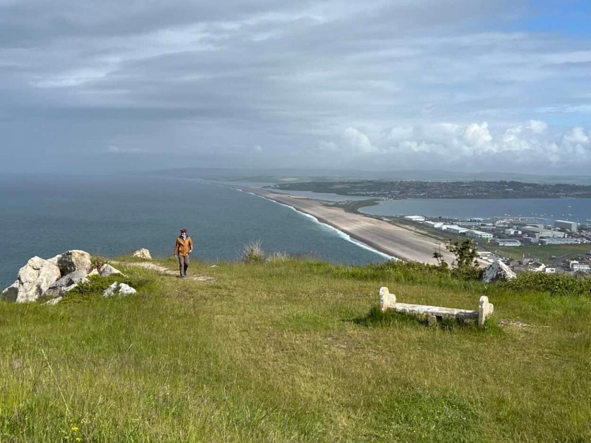 Scott McConkey, travel writer and founder of the Miles with McConkey Travel Blog, hikes in Tout Quarry overlooking Portland, England.