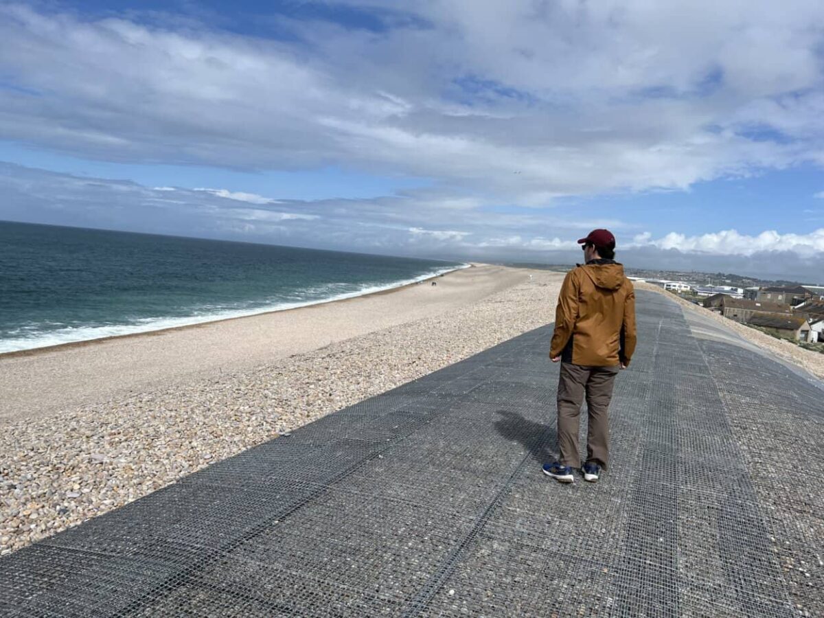 Scott McConkey, travel writer and founder of the Miles with McConkey Travel Blog, walks a section of Chesil Beach, Portland, England.