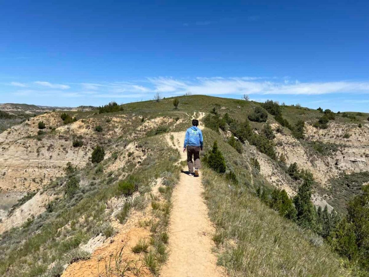 Scott McConkey, travel writer and founder of Miles with McConkey Travel Blog, hikes in Theodore Roosevelt National Park.