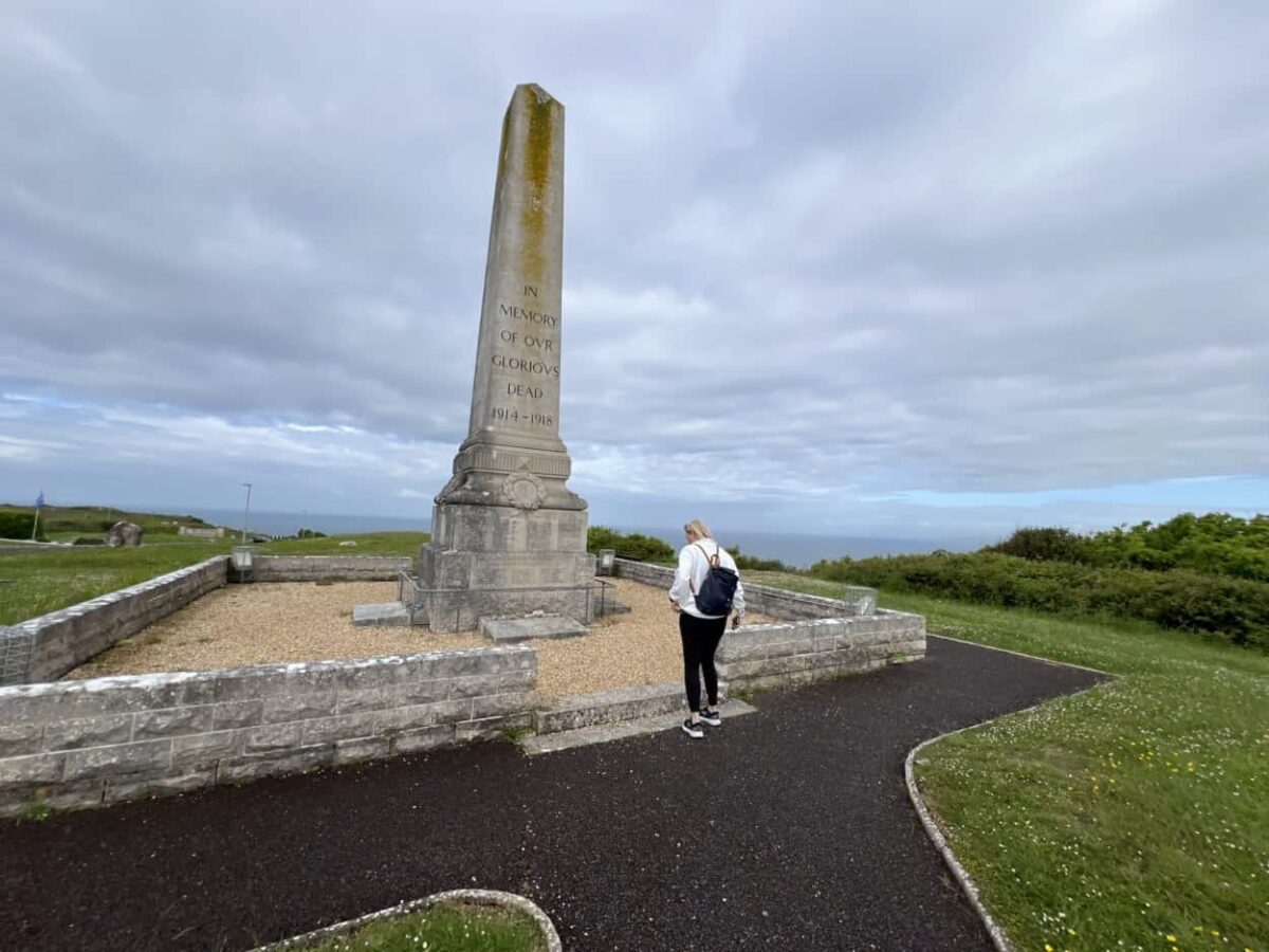 A woman looks at a war memorial in Portland, Dorset, United Kingdom