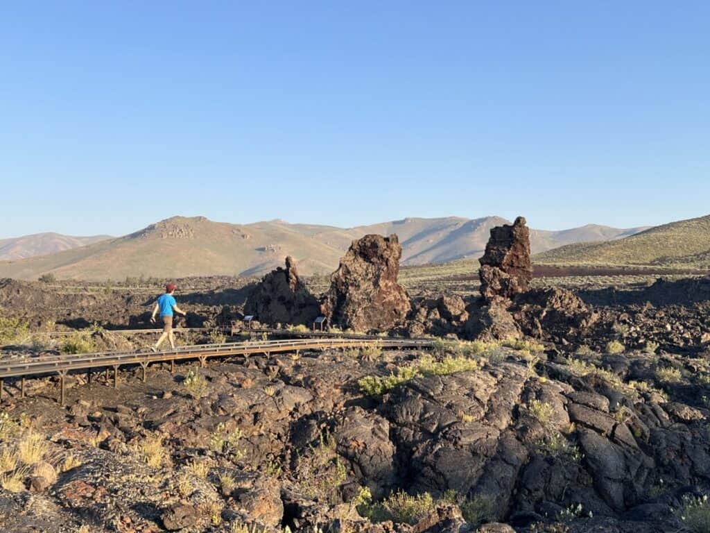 Scott McConkey, travel writer and founder of the Miles with McConkey Travel Blog, hikes a trail in Craters of the Moon National Monument and Reserve.