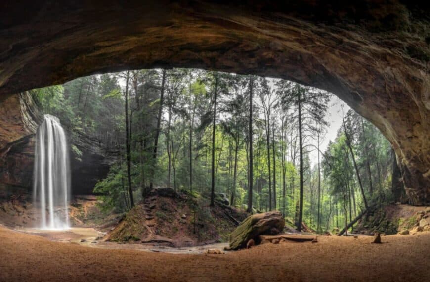 Looking out of a cave at a waterfall