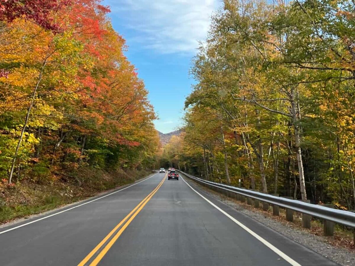 Cars drive on the Kancamagus Highway, NH.