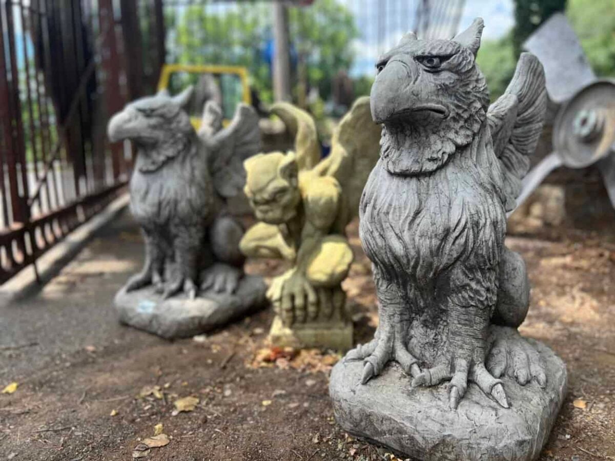 Thee stone gargoyles sit on the ground at Black Dog Salvage in Roanoke, Virginia