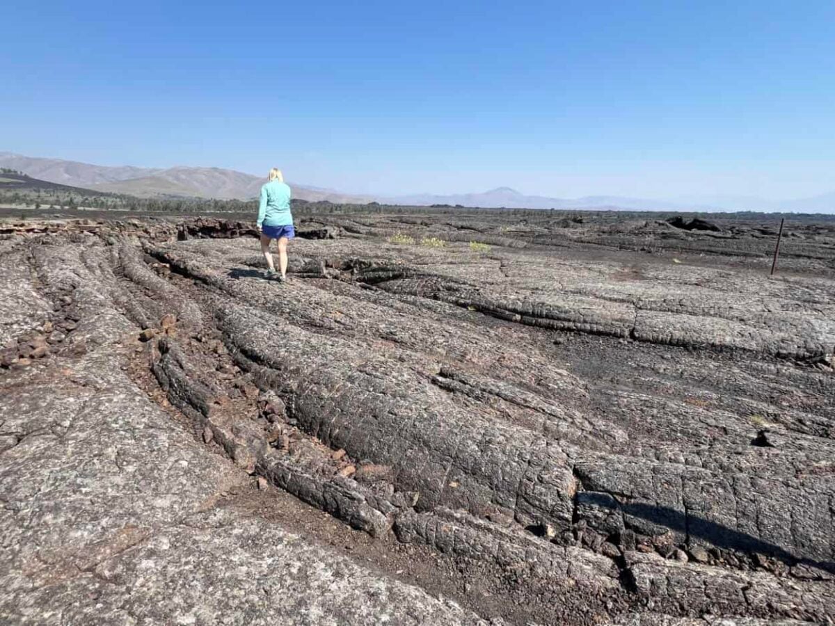 Julie McConkey walks on rugged lava terrain in Craters of the Moon National Monument and Preserve.