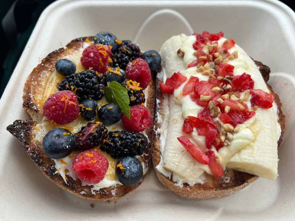 A container holds two pieces of toast topped with fruit at the Tanana Valley Farmers Market in Fairbanks, Alaska.