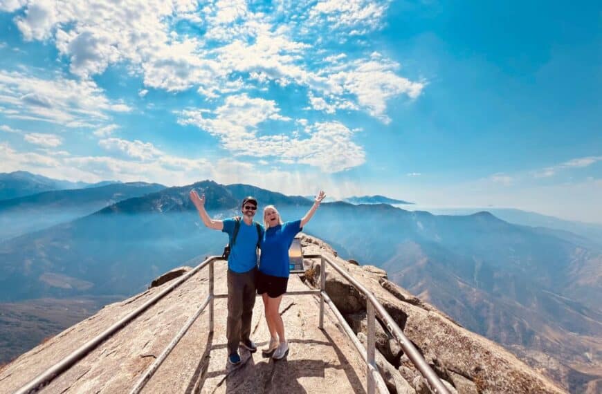 Scott McConkey and Julie McConkey of the Miles with McConkey Travel Blog celebrate reaching the top of Moro Rock Trail in Sequoia National Park.
