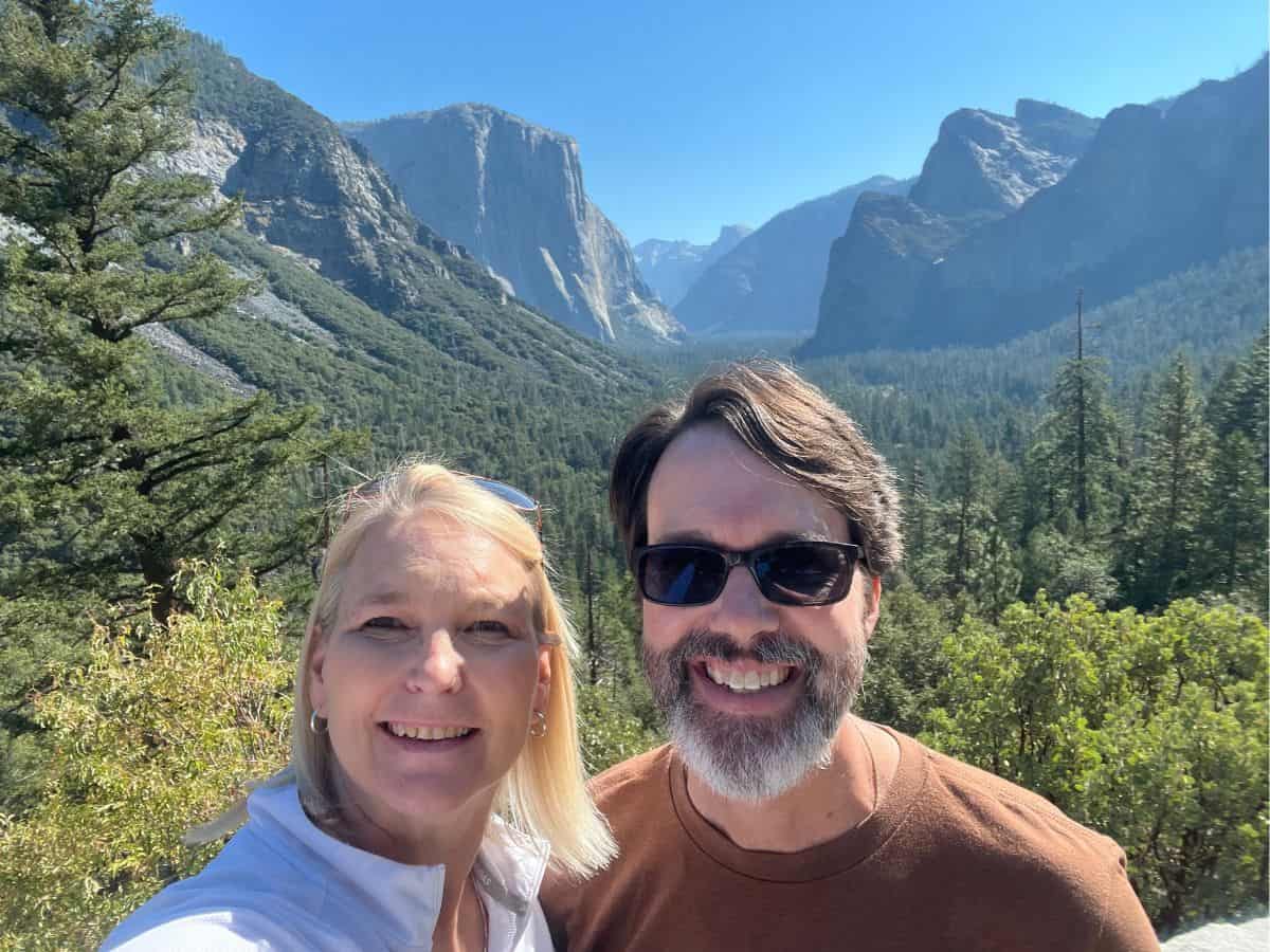 Scott McConkey and Julie McConkey of the Miles with McConkey Travel Blog pose for a picture at Tunnel View in Yosemite National Park.