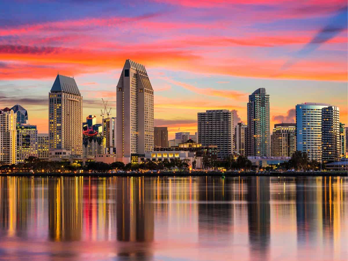 Clouds appear orange above the San Diego skyline near sunset