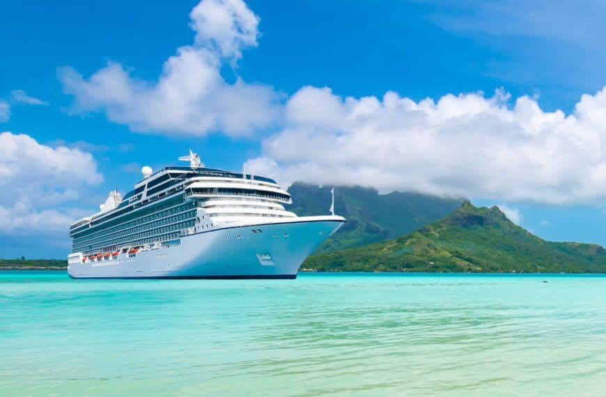 A cruise ship sits near a tropical island.