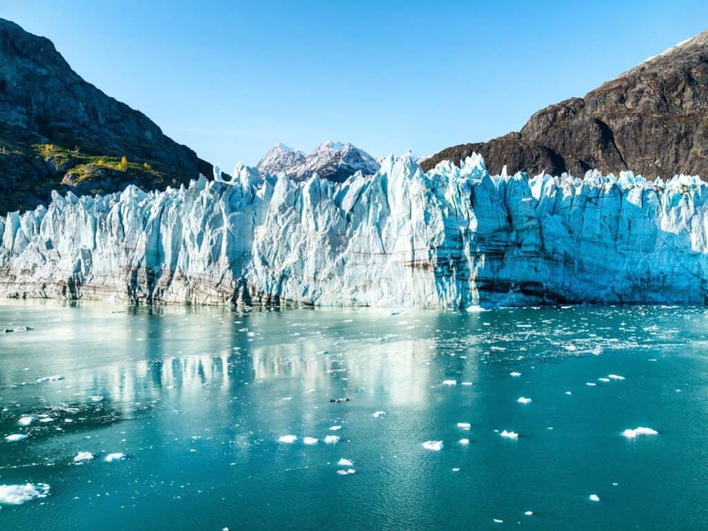 Icebergs float in the water near a glacier in Glacier Bay, Alaska