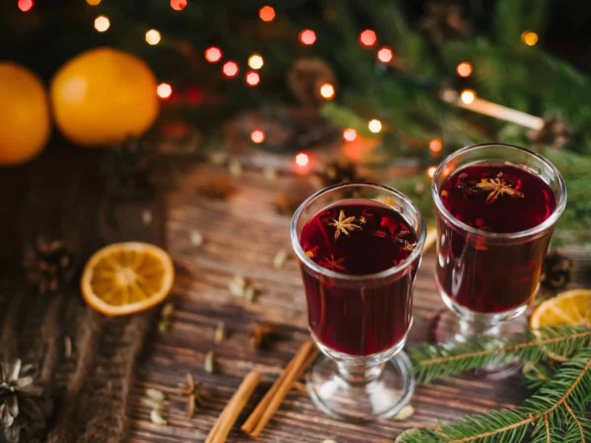 Two glasses of mulled wine sit on a table