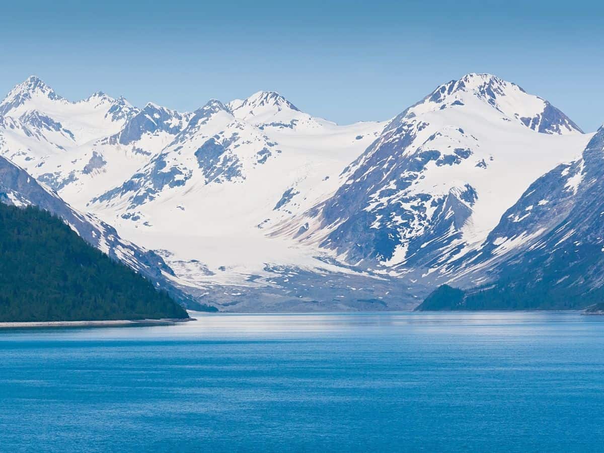 Snowy mountains dominate the horizon in Glacier Bay, Alaska.