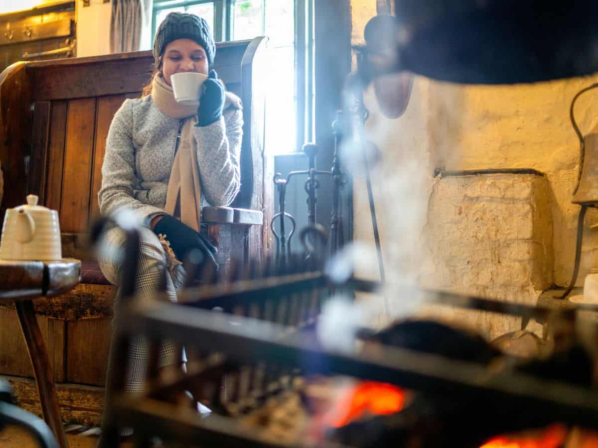 A warm sips a cup of coffee in a pub