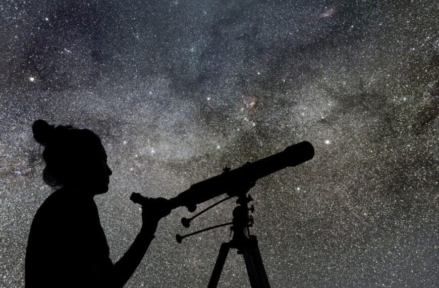 A woman prepares to look at stars through a telescope